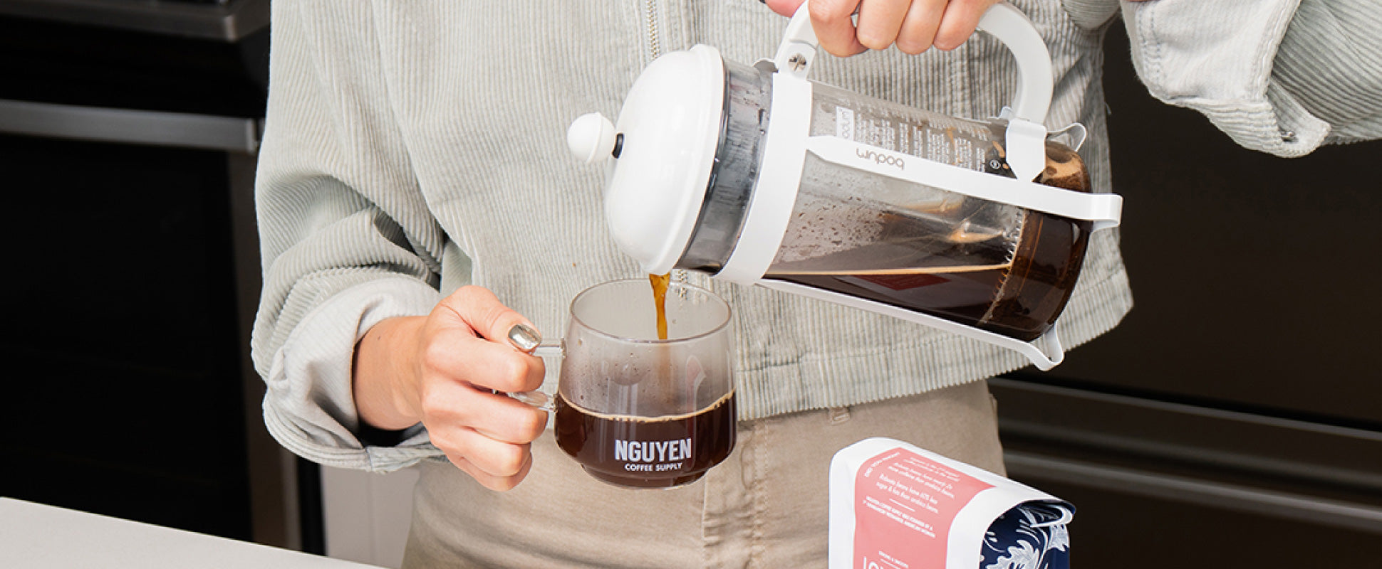 Making cold brew coffee with milk in a french press, also known as a  cafetière, coffee press, or coffee plunger Stock Photo