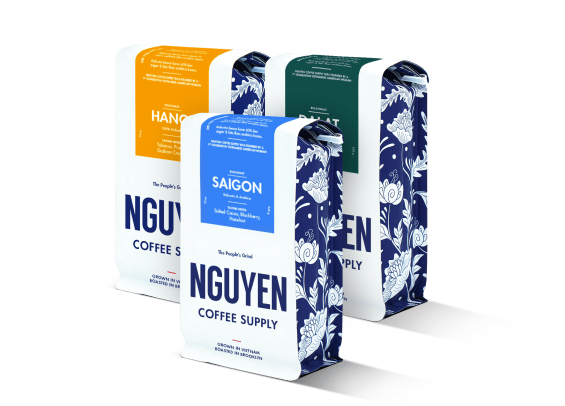 Cans of Nguyen Coffee Supply Classic Black, a Vietnamese cold brew coffee, arranged in a group.